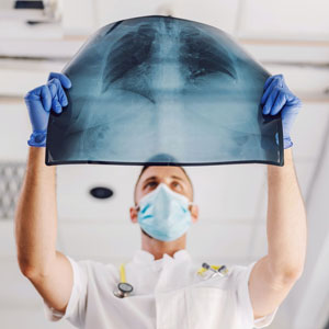 A doctor examining a x-ray - Sexton Weldon Law Firm.